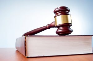 judges gavel and law book on a blue background for a dayton criminal attorney